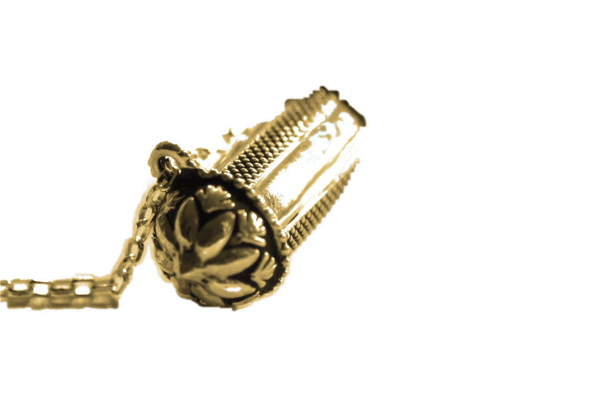 Pushpa Kavacha gold flower end cap detail on white background