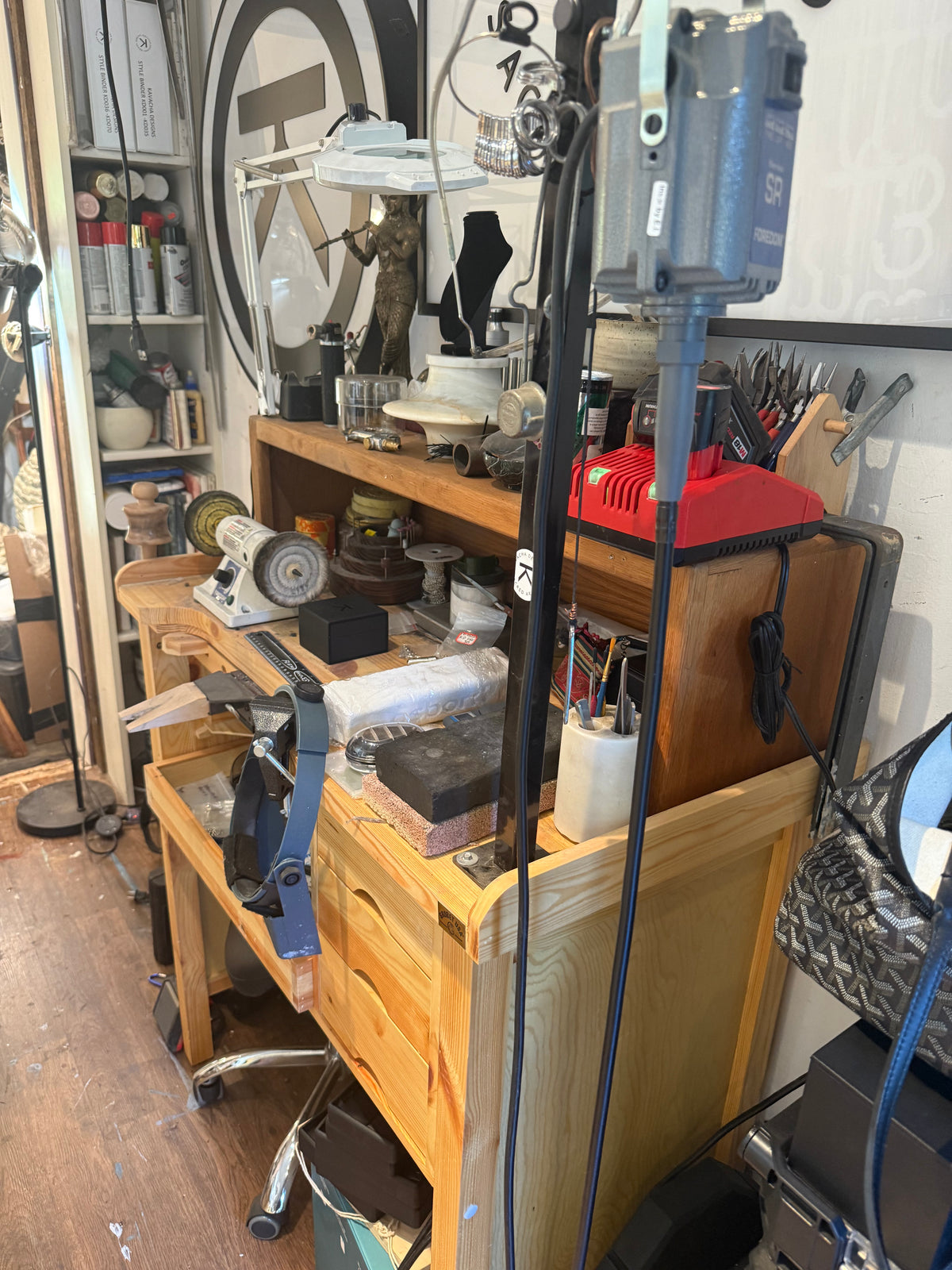 Jewelry tools, a vise and a polishing wheel at Jayashri’s studio workbench.