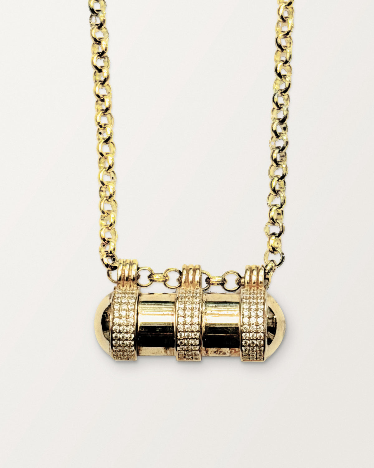 Agraja openable amulet necklace in 14K or 18K yellow gold, shown closed on its chain.