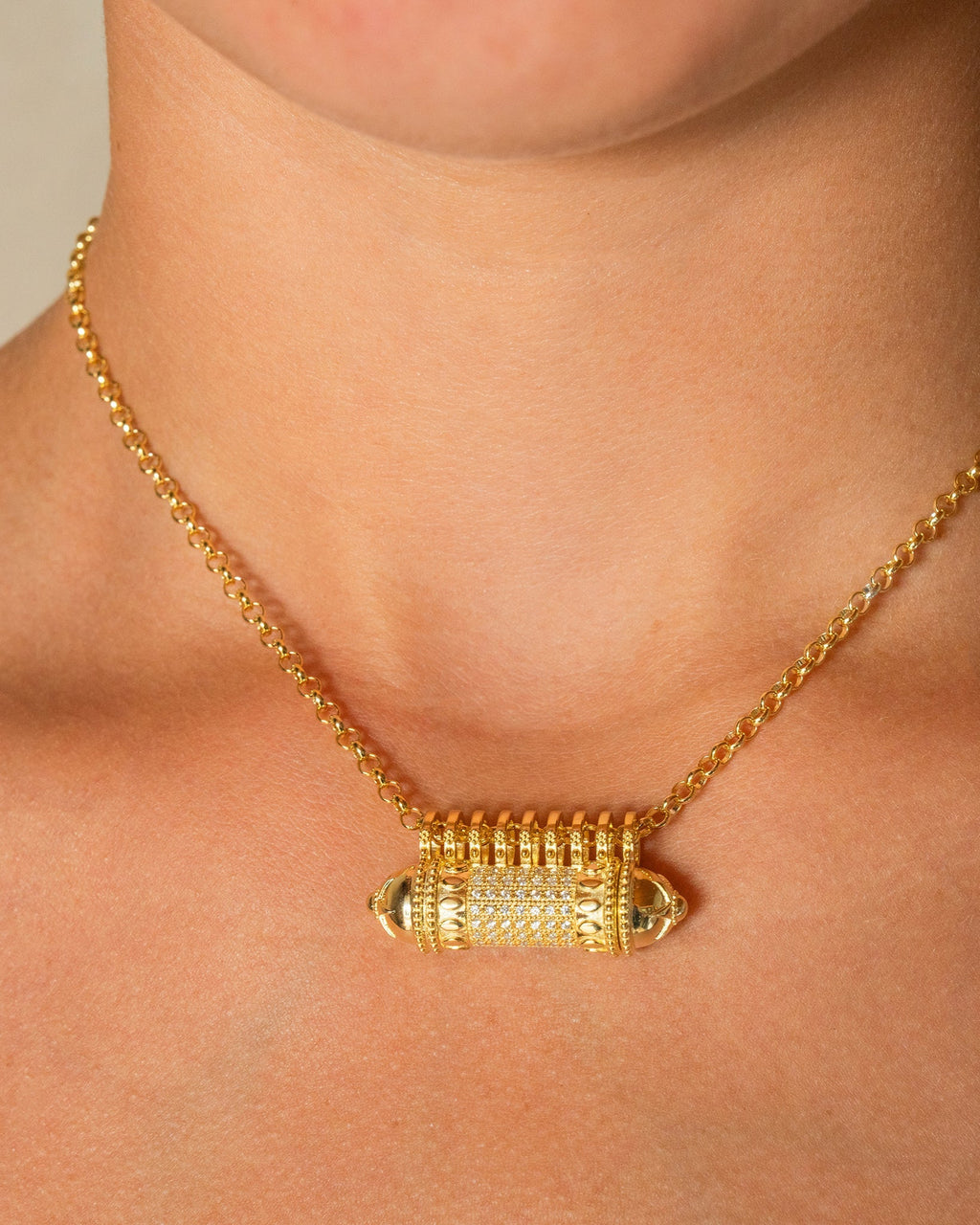 Antique Pave openable amulet necklace in 14K or 18K yellow gold, worn by a model.