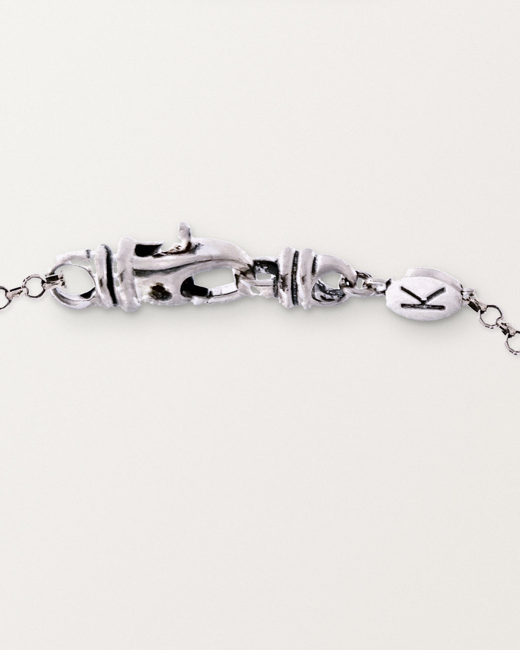 The medium Kavacha clasp with its branded K tag, in sterling silver.