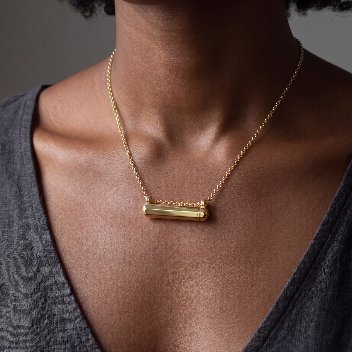 Kerala Small openable amulet necklace in 14K or 18K yellow gold, worn close to the heart. Generated portrait based on product photographs, with measured gold colour correction.