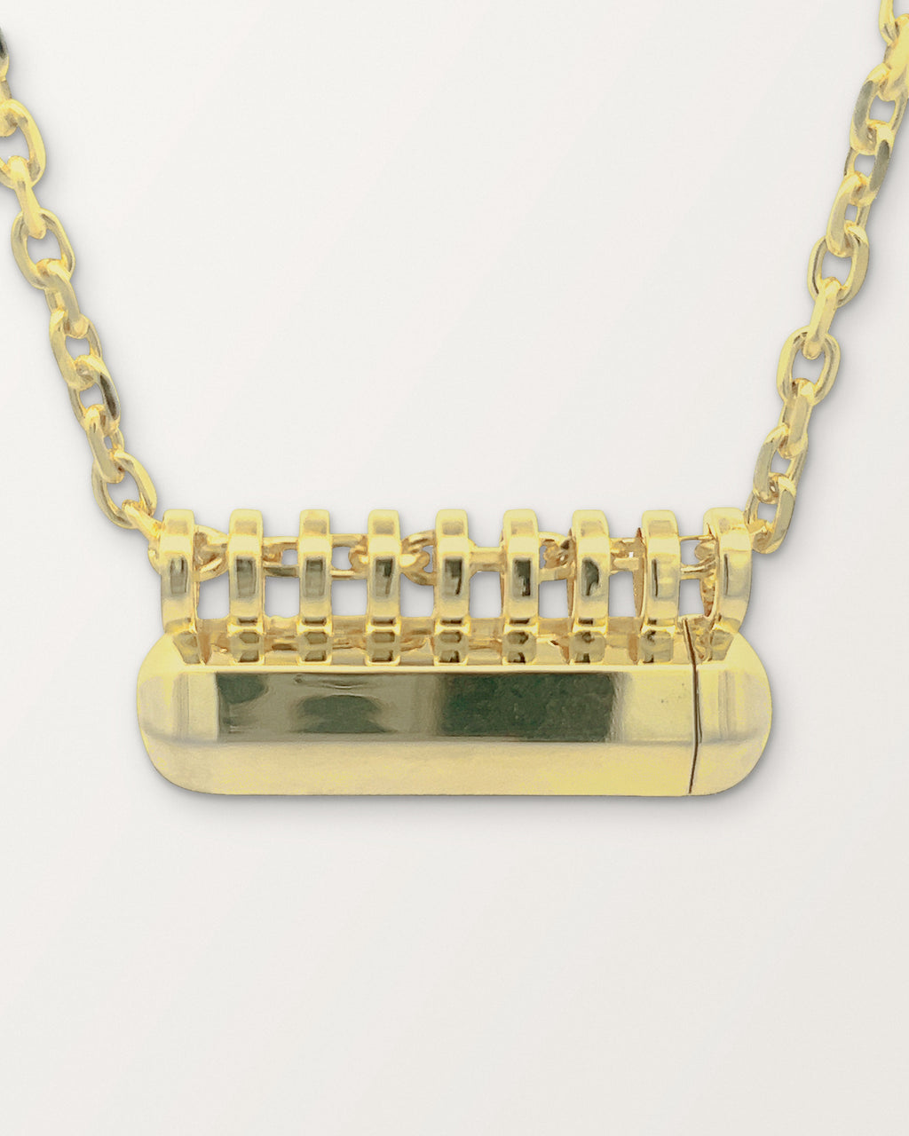 Close-up of the Kerala Large amulet in 14K or 18K yellow gold showing the row of bails and the faceted body.