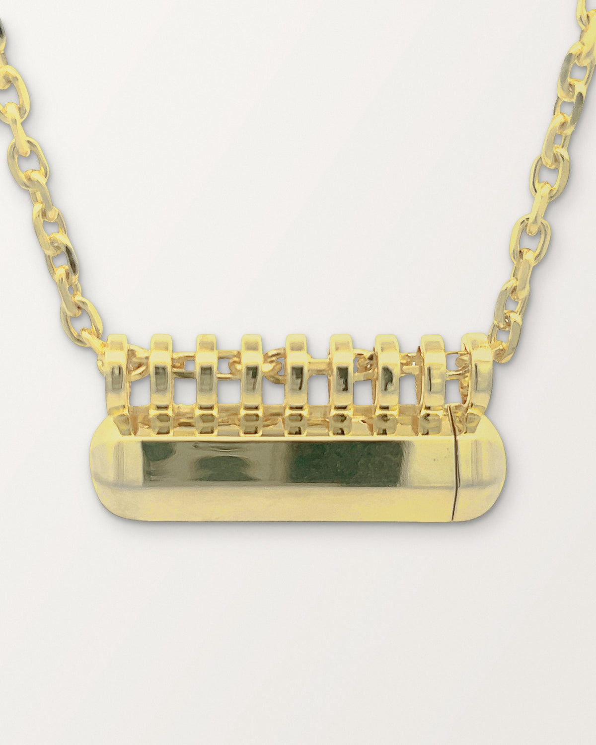Close-up of the Kerala Large amulet in 14K or 18K yellow gold showing the row of bails and the faceted body.