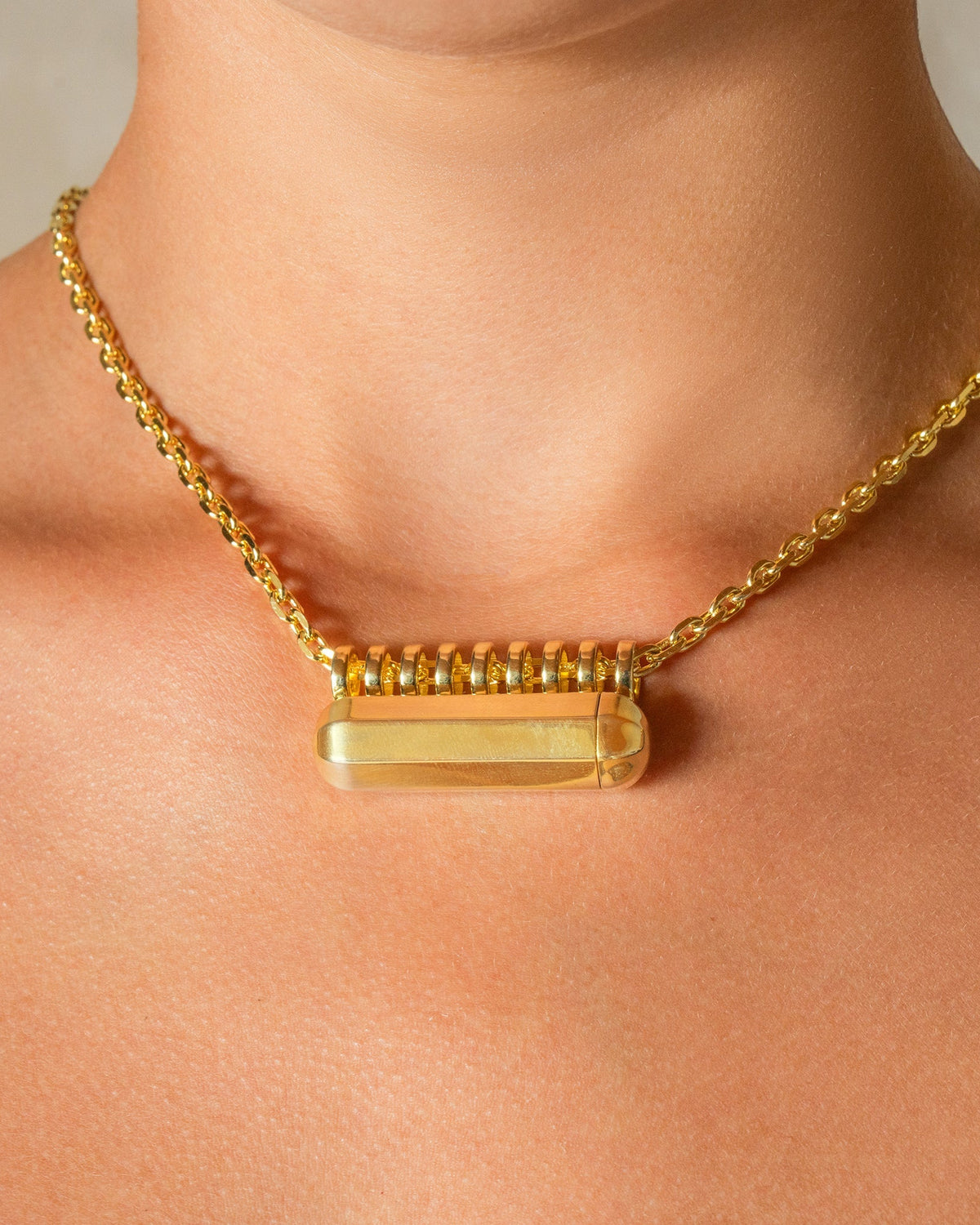Kerala Large openable amulet necklace in 14K or 18K yellow gold, worn by a model.