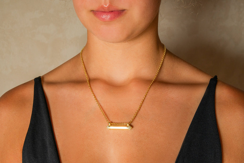 Kerala Pave openable amulet necklace in solid gold, worn by a model.