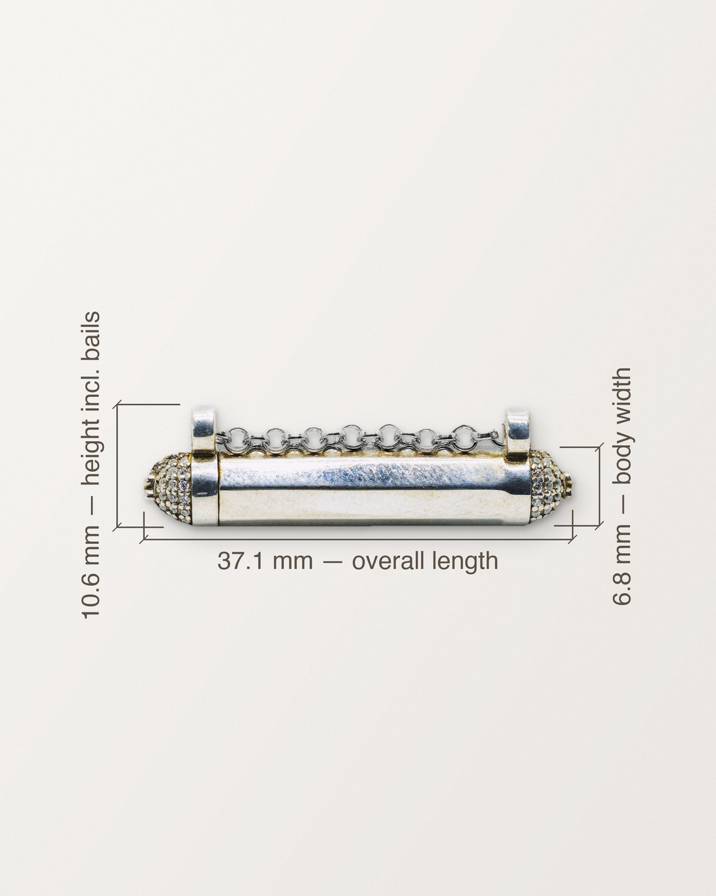 Sterling silver Kerala Pave amulet with its measurements: 37.1 mm long, 6.8 mm across the body, 10.6 mm tall including the bails.