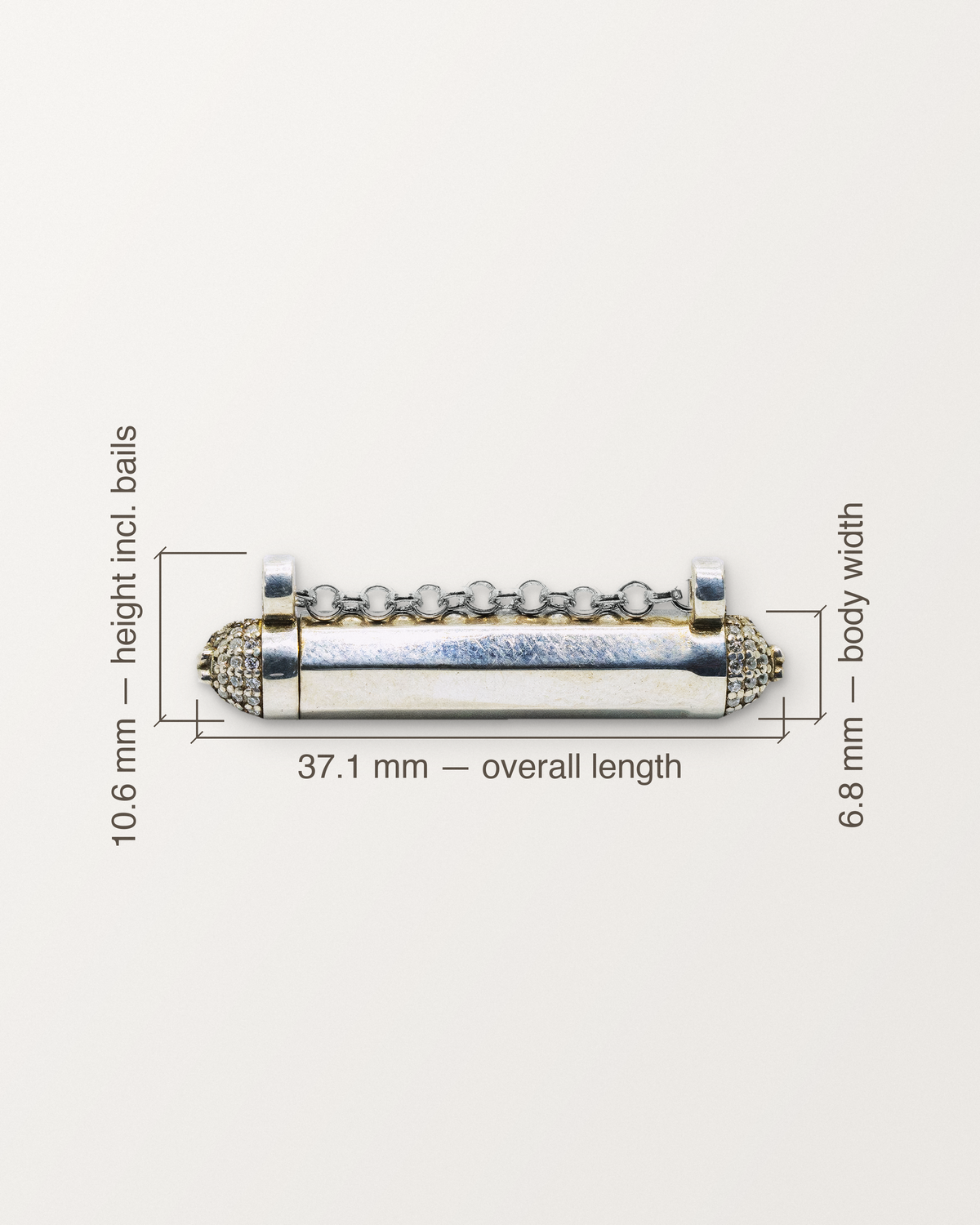 Sterling silver Kerala Pave amulet with its measurements: 37.1 mm long, 6.8 mm across the body, 10.6 mm tall including the bails.