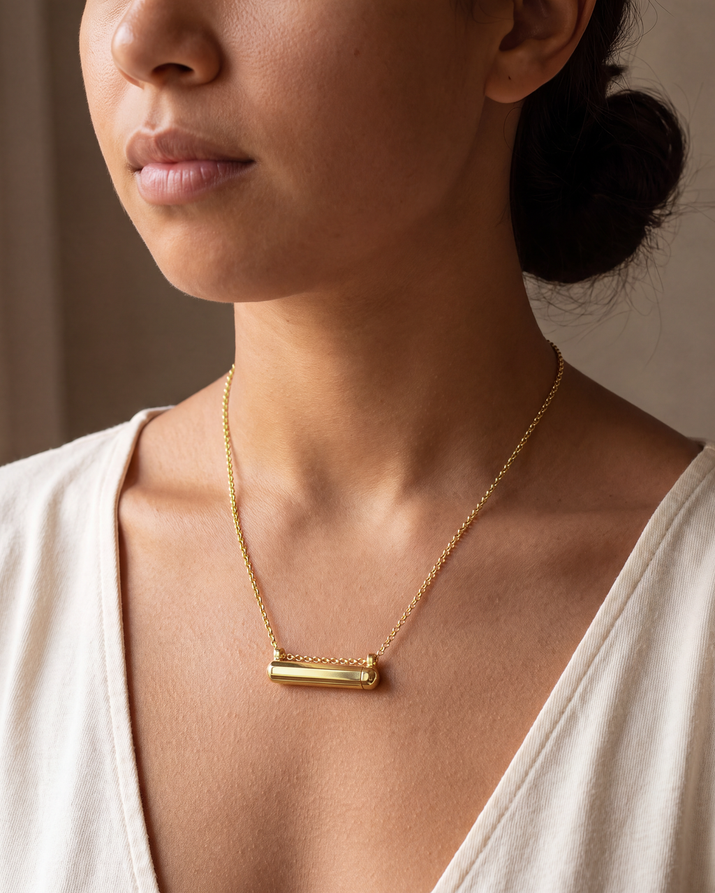Kerala Small amulet necklace in 14K or 18K yellow gold, worn at the collarbone (illustrative scene).