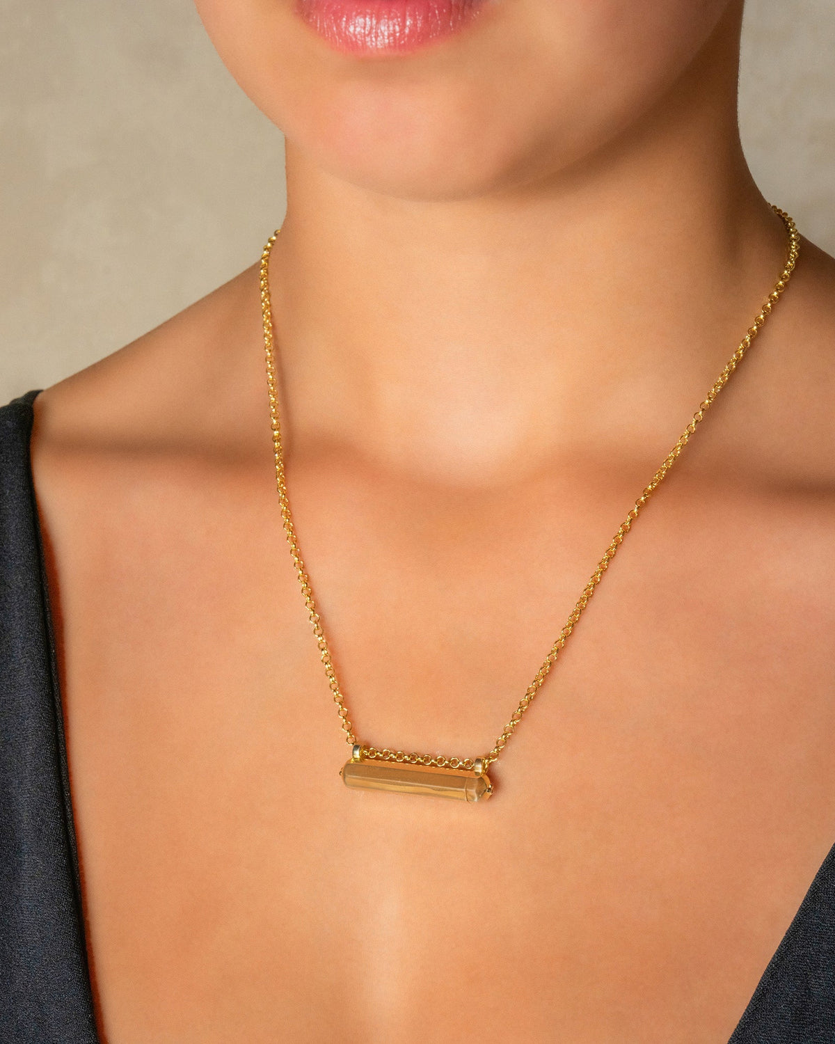 Kerala Small openable amulet necklace in 14K or 18K yellow gold, worn by a model.