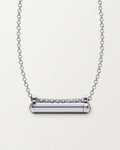 Sterling silver Kerala Small amulet necklace, closed, on a warm bone-white background, chain exiting the top of frame.