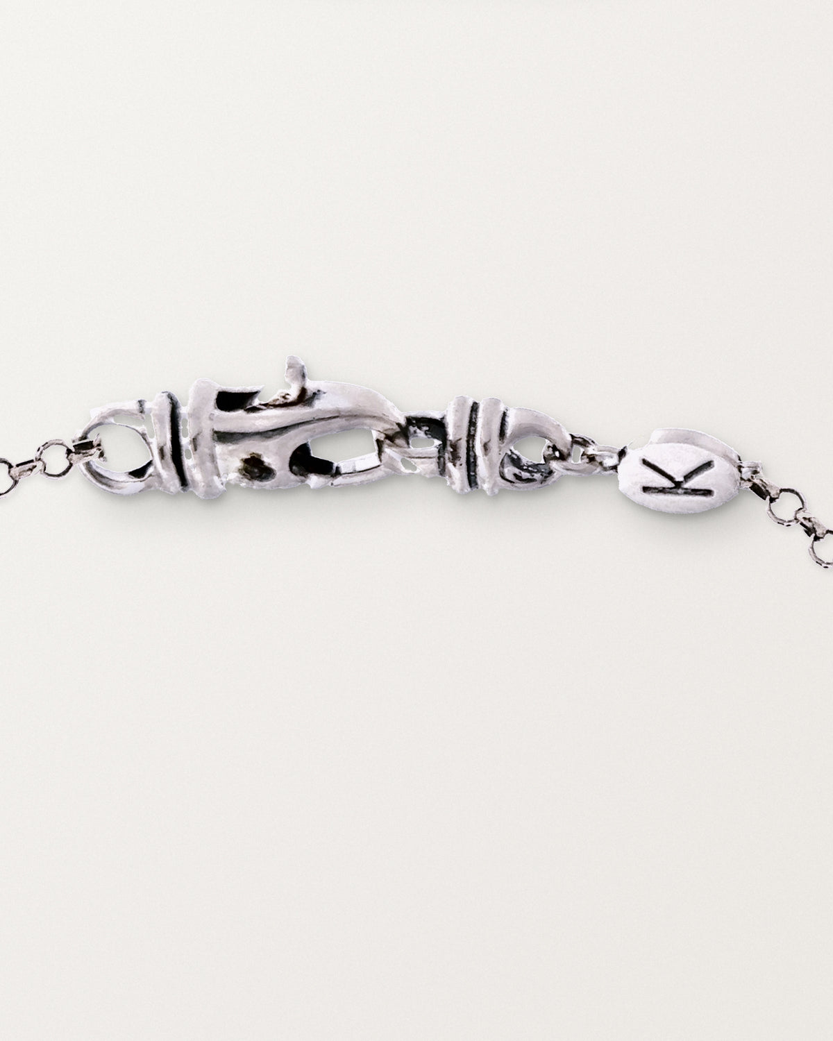 The medium Kavacha clasp with its branded K tag, in sterling silver.