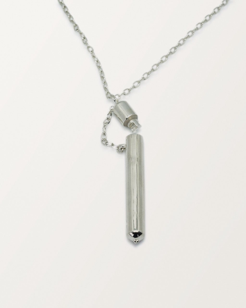 Moksha amulet necklace in sterling silver, shown open with the chamber visible.