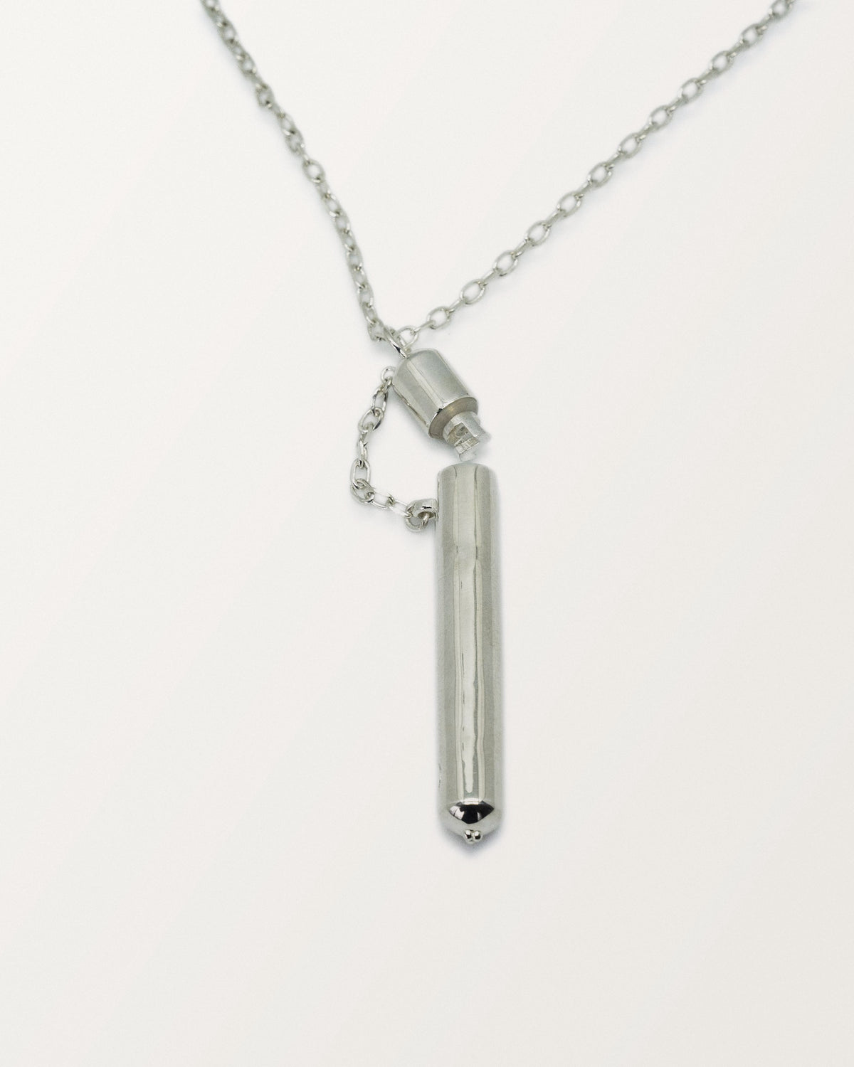 Moksha amulet necklace in sterling silver, shown open with the chamber visible.