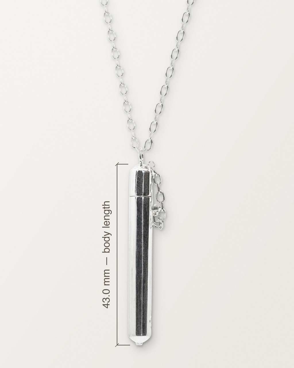 Sterling silver Moksha amulet on its chain with its measurement: 43.0 mm long from the top of the dome to the bottom of the granules.