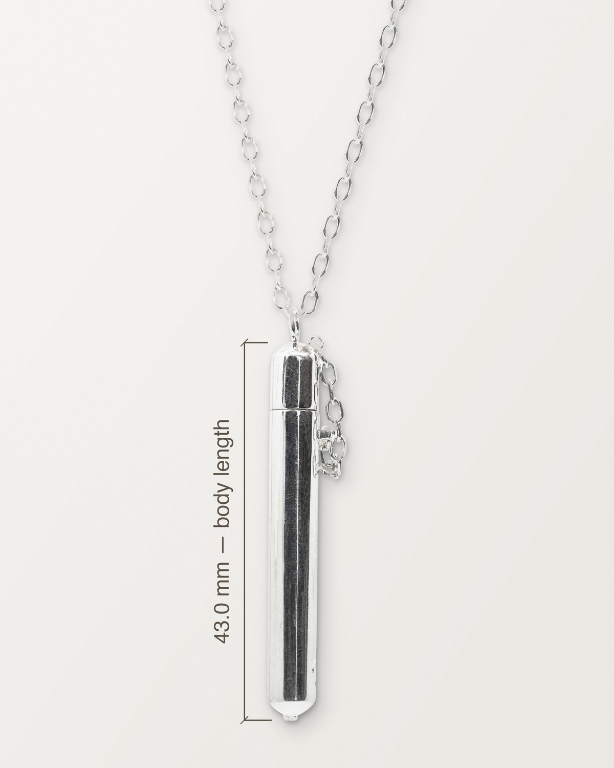 Sterling silver Moksha amulet on its chain with its measurement: 43.0 mm long from the top of the dome to the bottom of the granules.