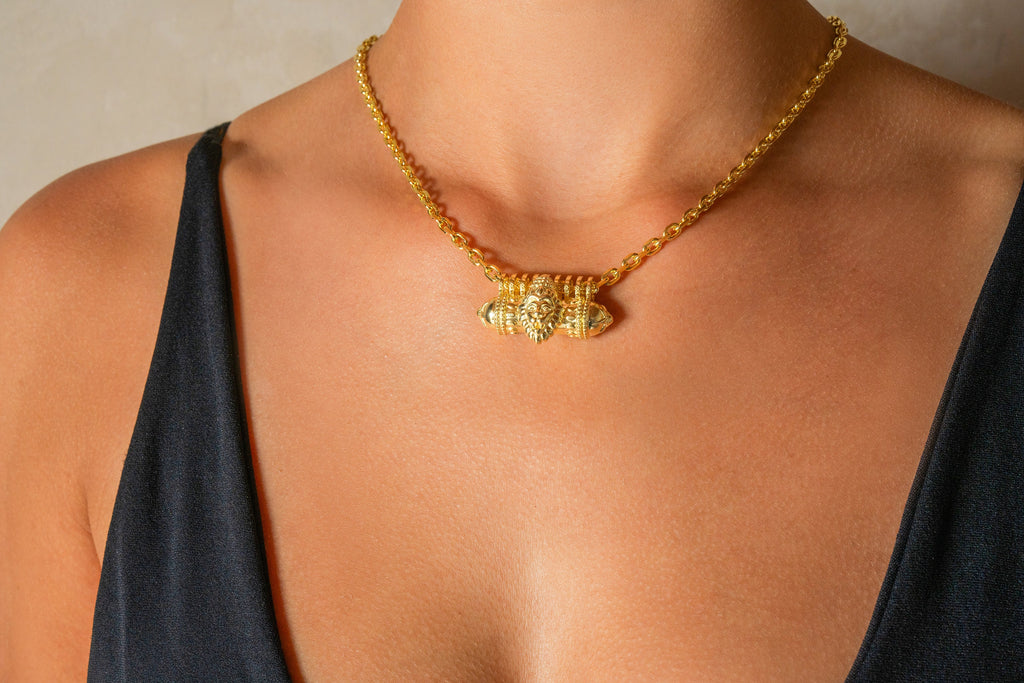 Narashimha openable amulet necklace, gold-plated sample worn by a model. Made to order in 14K or 18K yellow gold.