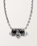 Sterling silver Narashimha amulet necklace, closed, on its heavy oval cable chain against a warm bone-white background.