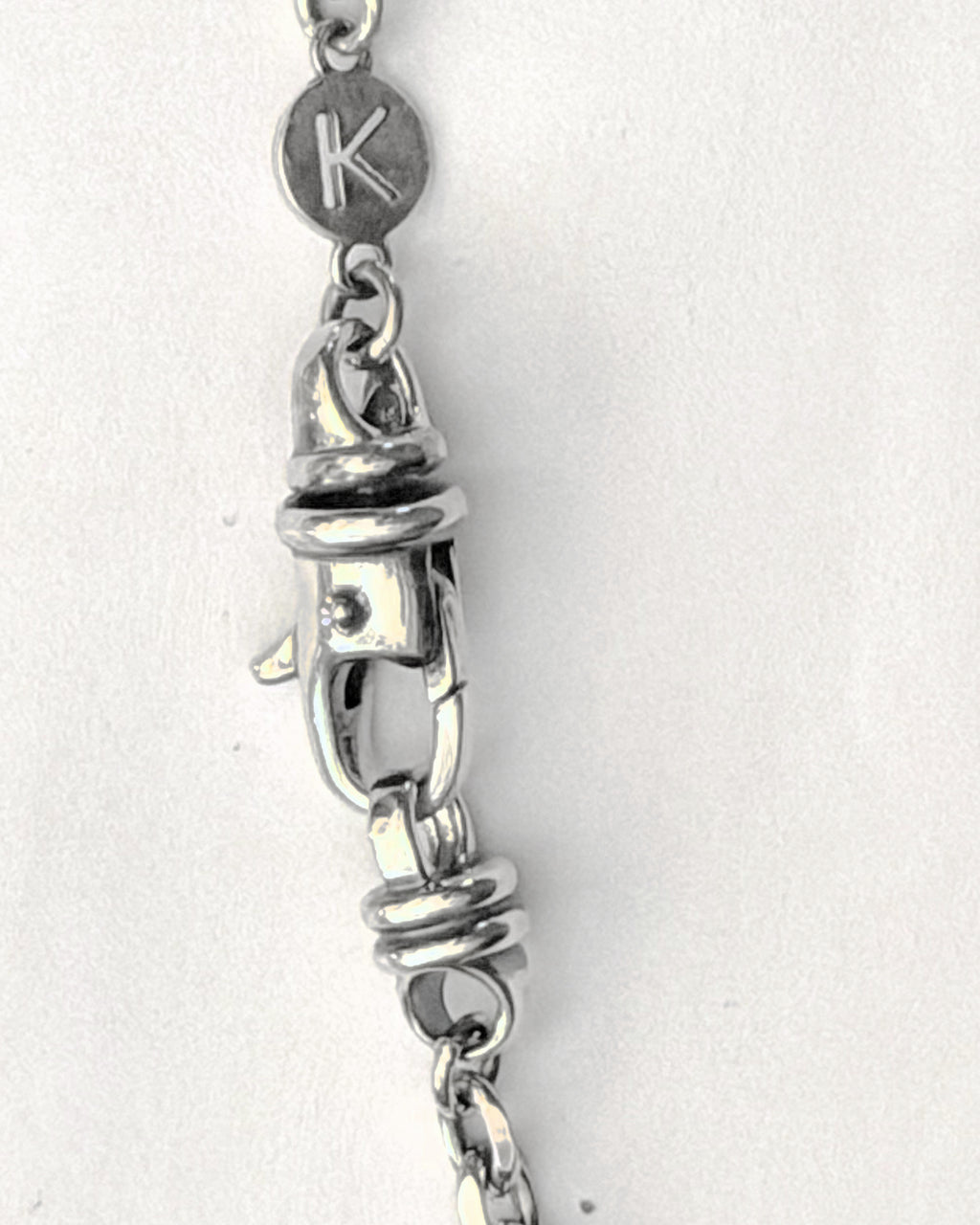 The large Kavacha clasp with its branded K tag, in sterling silver.