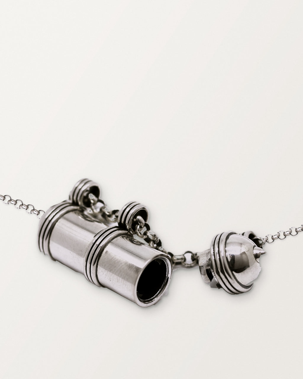 Pankaj amulet necklace in sterling silver, shown open: the body and its short domed cap, each on the chain, with the chamber visible.