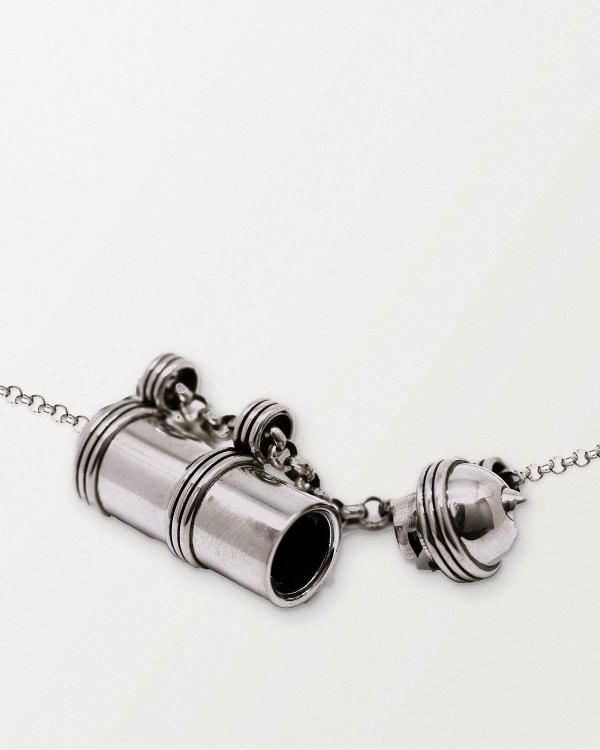 Pankaj amulet necklace in sterling silver, shown open: the body and its short domed cap, each on the chain, with the chamber visible.
