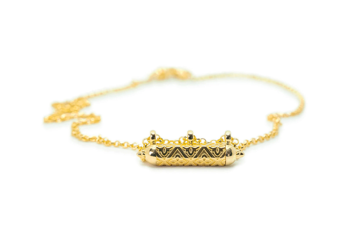Shakti openable amulet necklace in solid gold, shown closed on a neutral background.