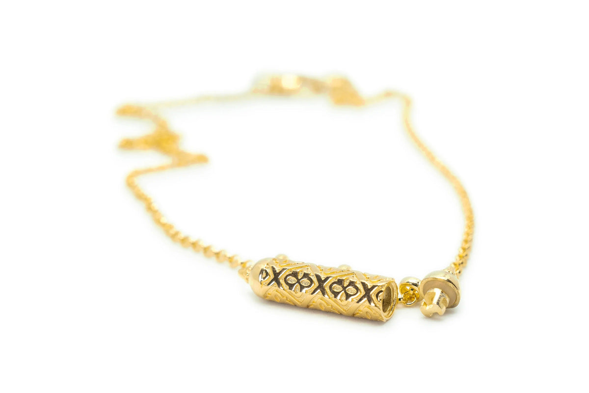 Shakti openable amulet necklace in solid gold, shown open with its cap and inner chamber visible.