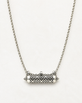 Shakti openable amulet necklace in sterling silver, shown closed on a warm bone-white background.
