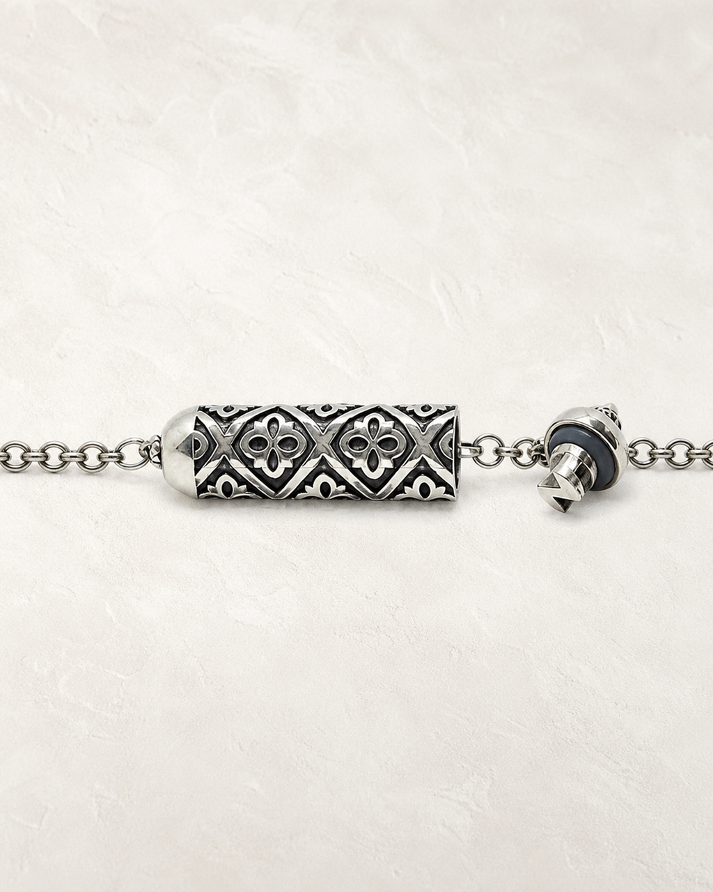 Shakti openable amulet necklace in sterling silver, shown open with the cap, gasket, chamber, and chain visible.