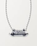 Sterling silver SOULROCKER amulet necklace, closed, engraved front, on its polished rolo chain against a warm bone-white background.