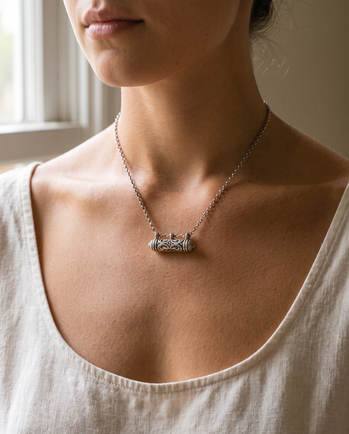 Sterling silver Sri amulet necklace, worn.