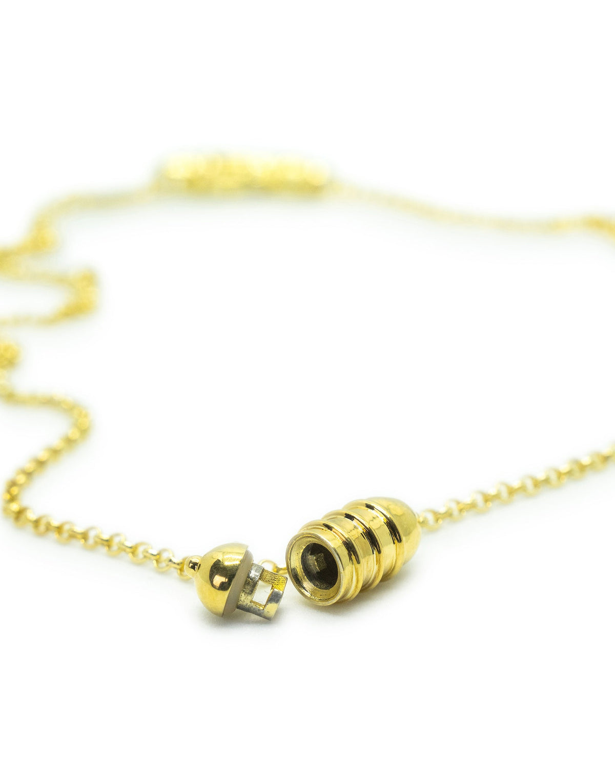 Vámana openable amulet necklace in 14K or 18K yellow gold, shown open.