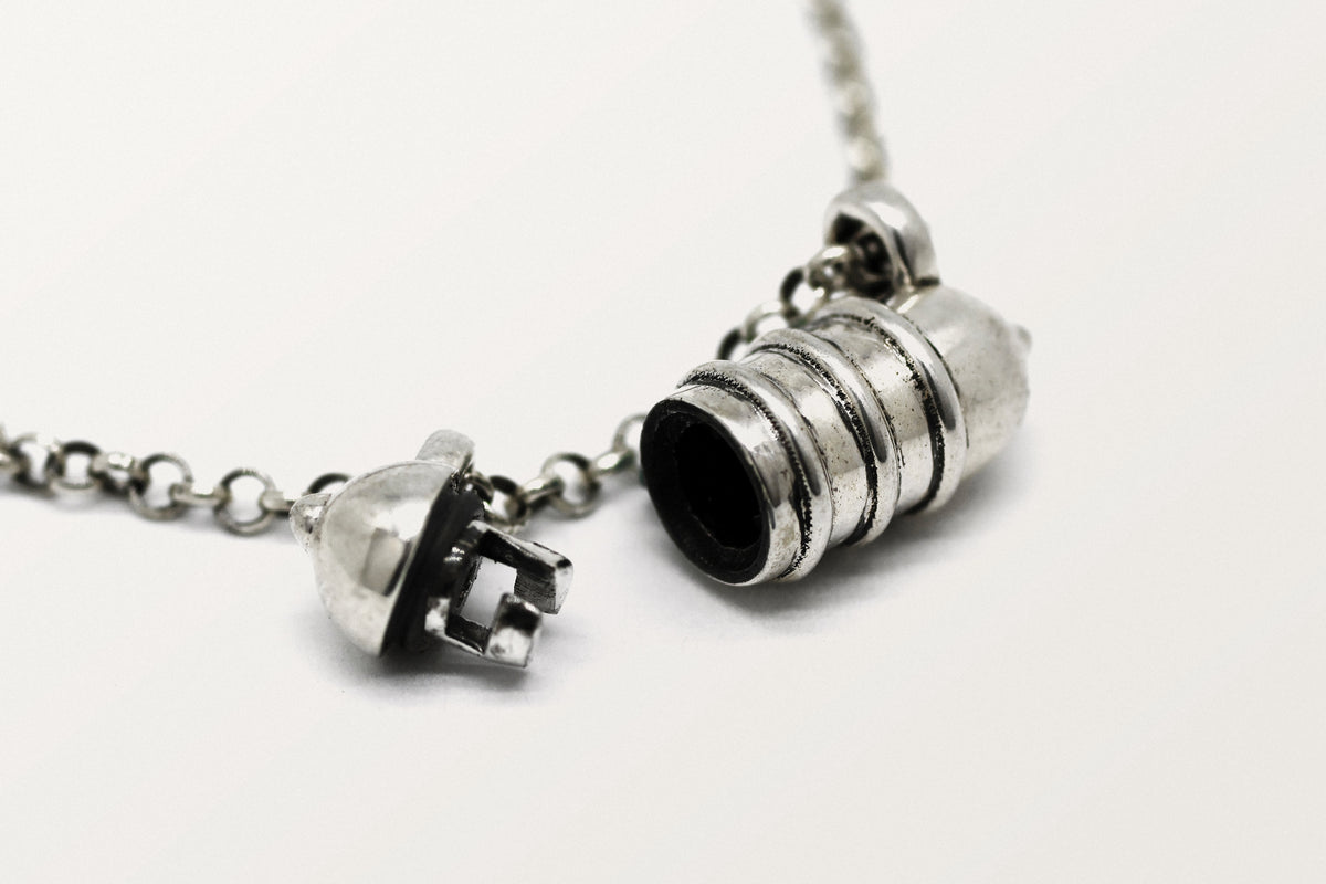 Vámana amulet necklace in sterling silver, shown open with the chamber visible.