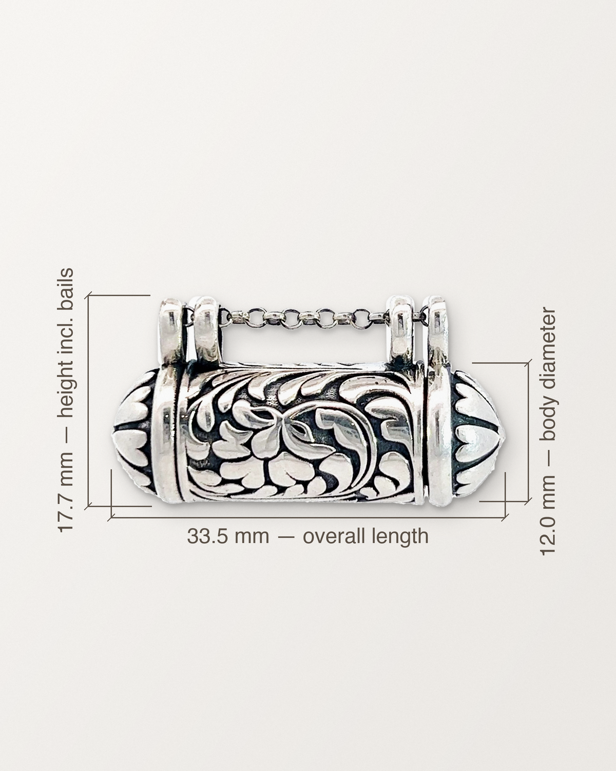 Sterling silver Vana amulet with its measurements: 33.5 mm long, 17.7 mm tall including the bails, 12.0 mm across.