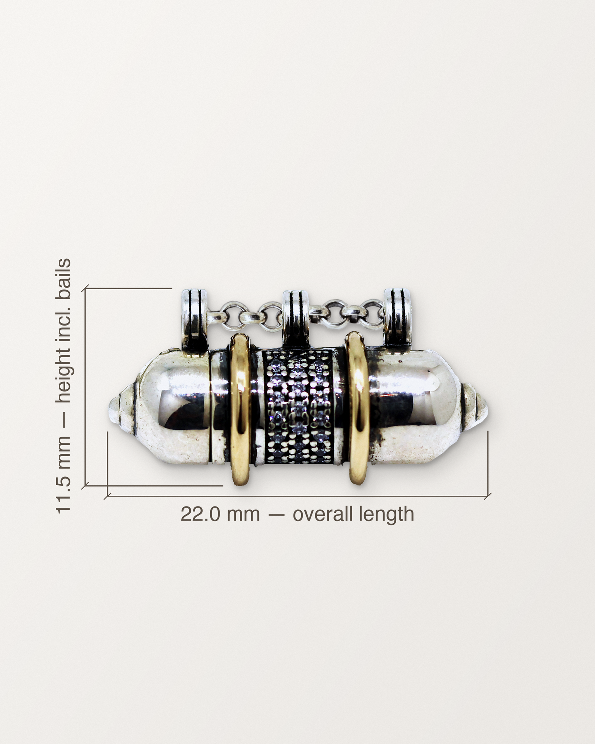Sterling silver Vidya amulet with its measurements: 22.0 mm long and 11.5 mm high.