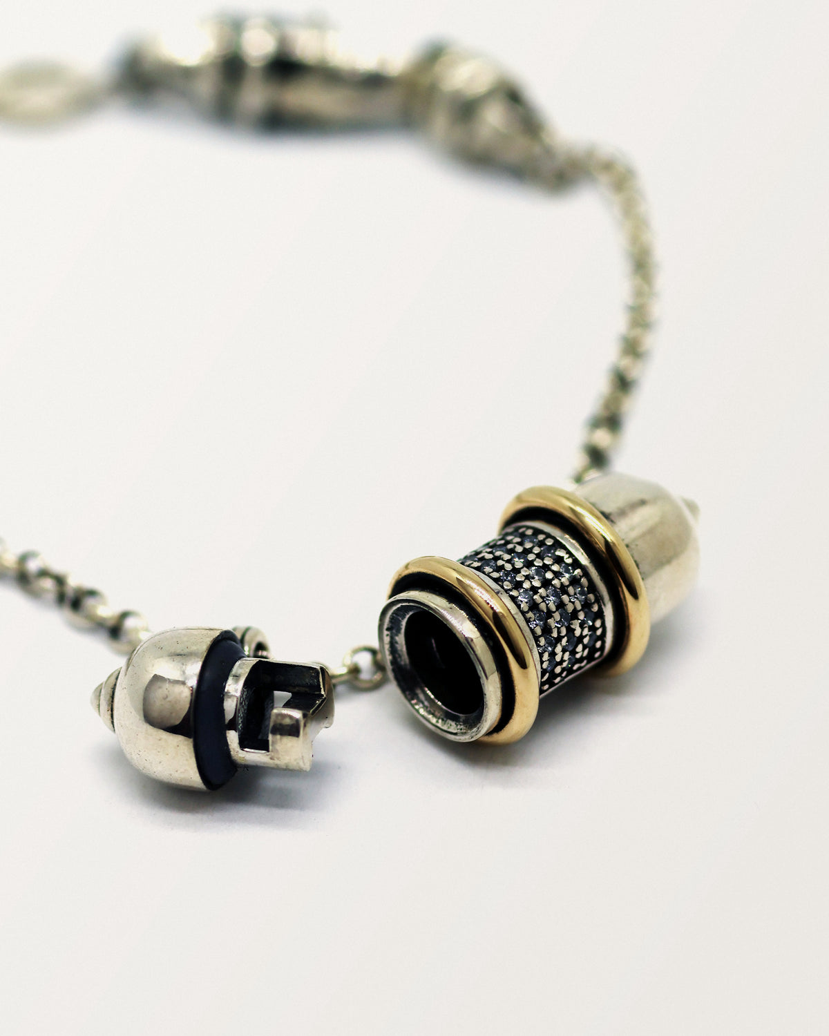Vidya amulet necklace in sterling silver with 14K yellow gold bands, shown open with the chamber visible.