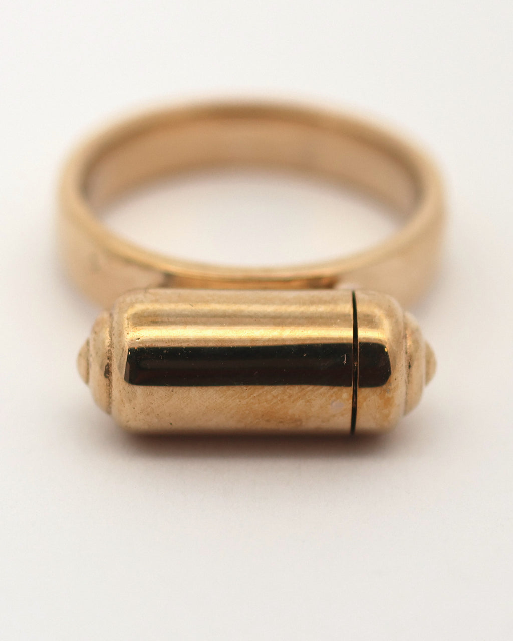 Close-up of the VRAT openable ring amulet in 14K yellow gold, shown closed.