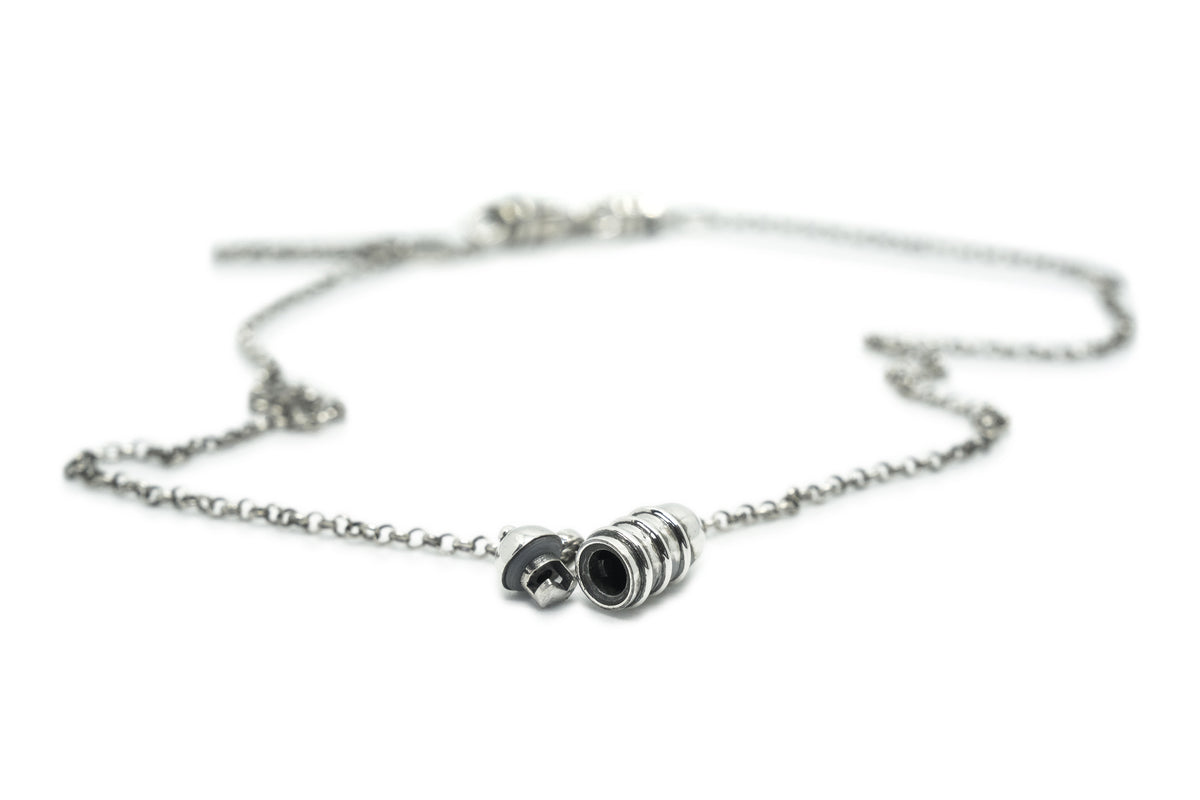 Vámana amulet necklace in sterling silver, shown open with the chamber visible.
