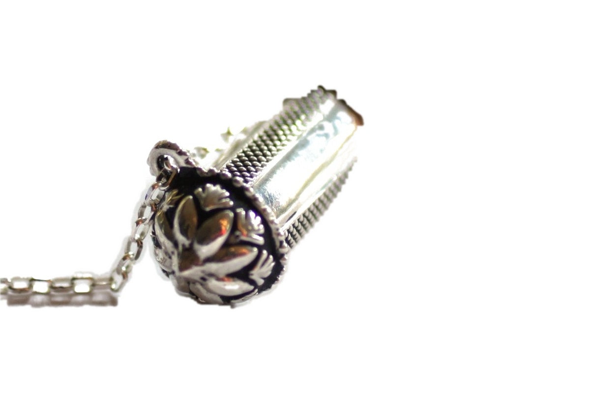 Pushpa Kavacha sterling silver flower end cap detail on white background