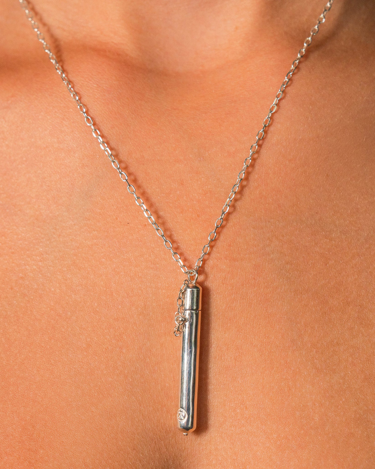 Moksha amulet necklace in sterling silver, worn by a model.