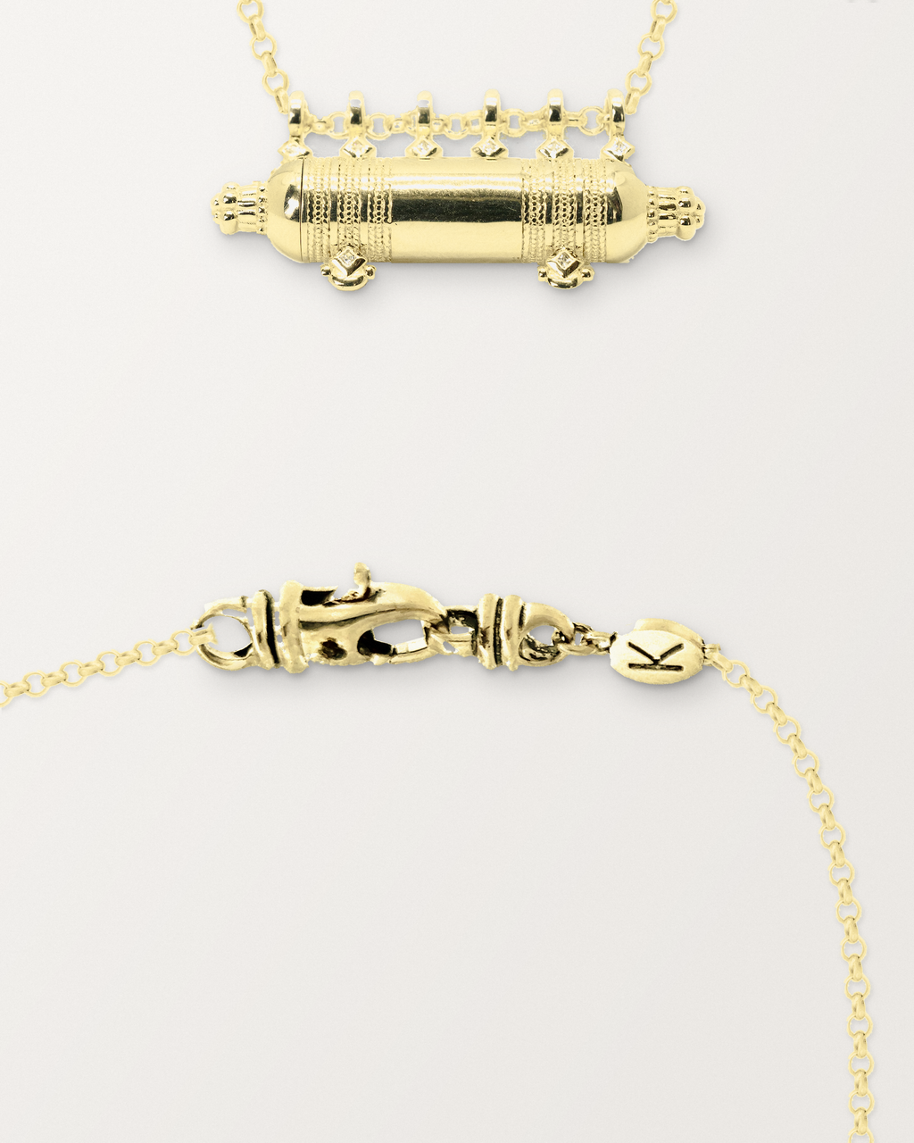 Yemen Wedding openable amulet necklace in 14K or 18K yellow gold, beside a close view of the lobster clasp and oval K tag on its chain.