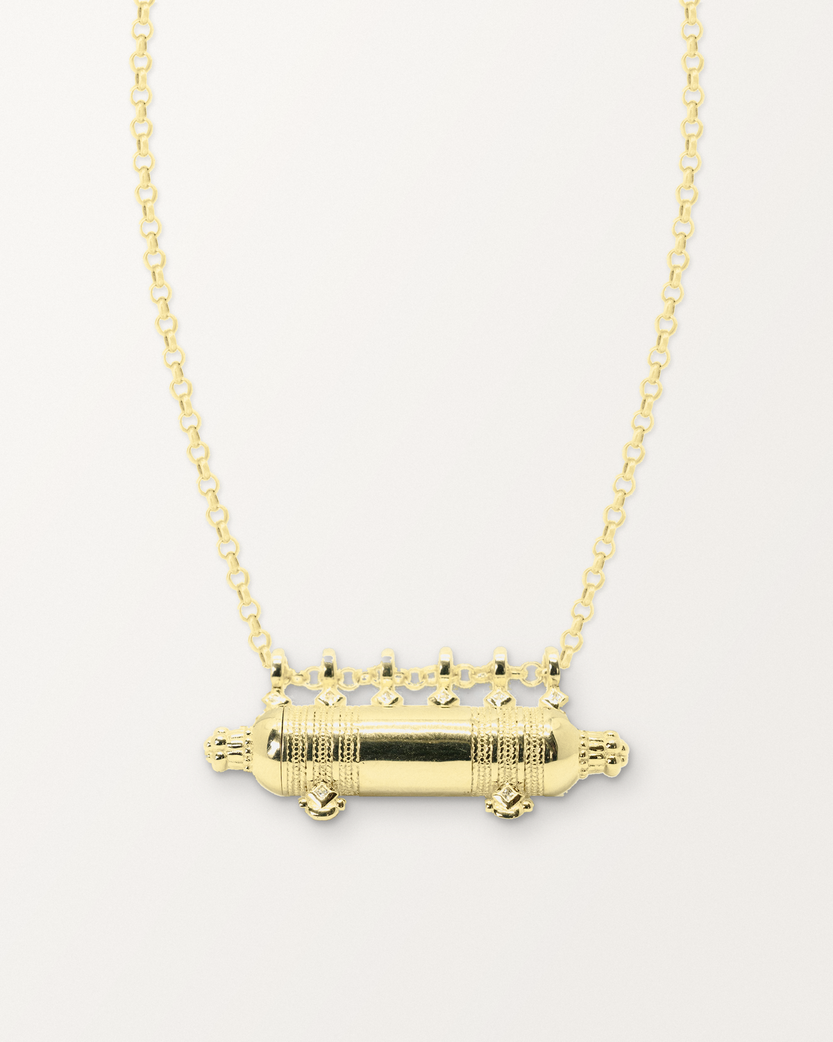 Yemen Wedding openable amulet necklace in 14K or 18K yellow gold, shown closed on a warm bone-white background.