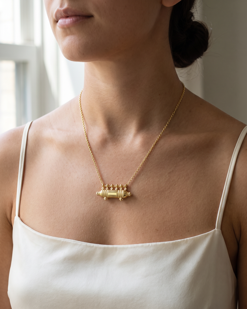 Yemen Wedding amulet necklace in 14K or 18K yellow gold, worn at the collarbone (illustrative scene)