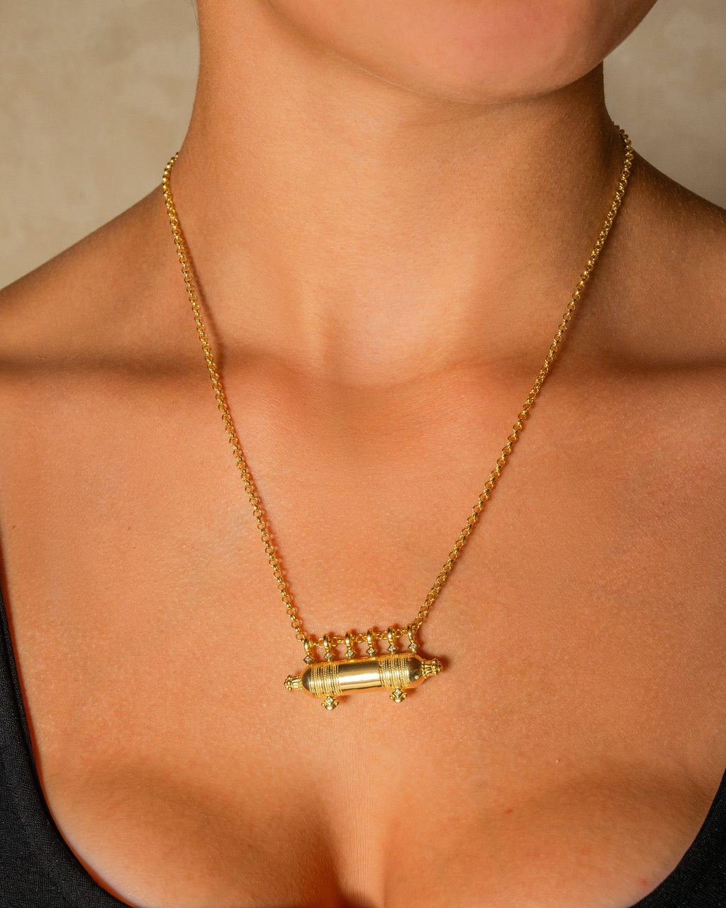 Yemen Wedding openable amulet necklace in 14K or 18K yellow gold, worn by a model.