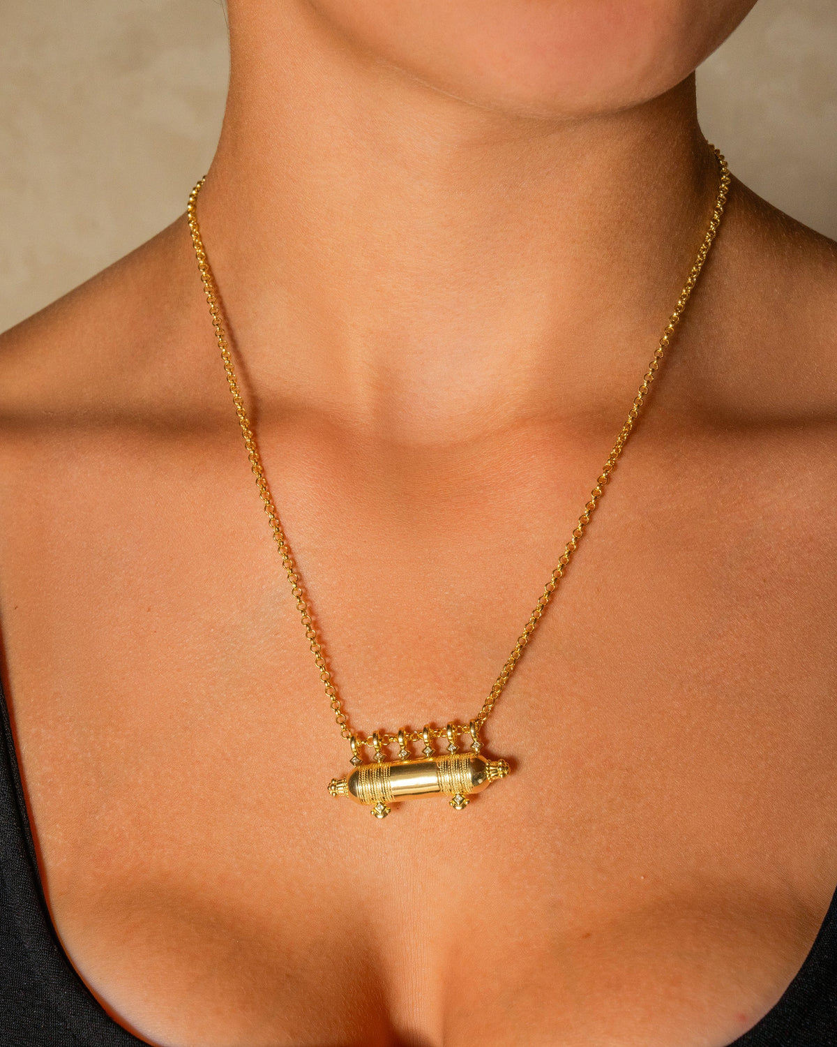 Yemen Wedding openable amulet necklace in 14K or 18K yellow gold, worn by a model.